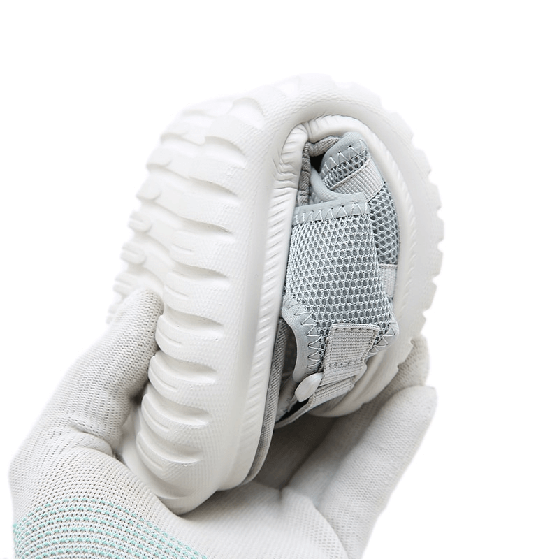 Soft and flexible sports lady's beach sandal with white textured sole and buckle straps, showcasing easy foldability for travel.