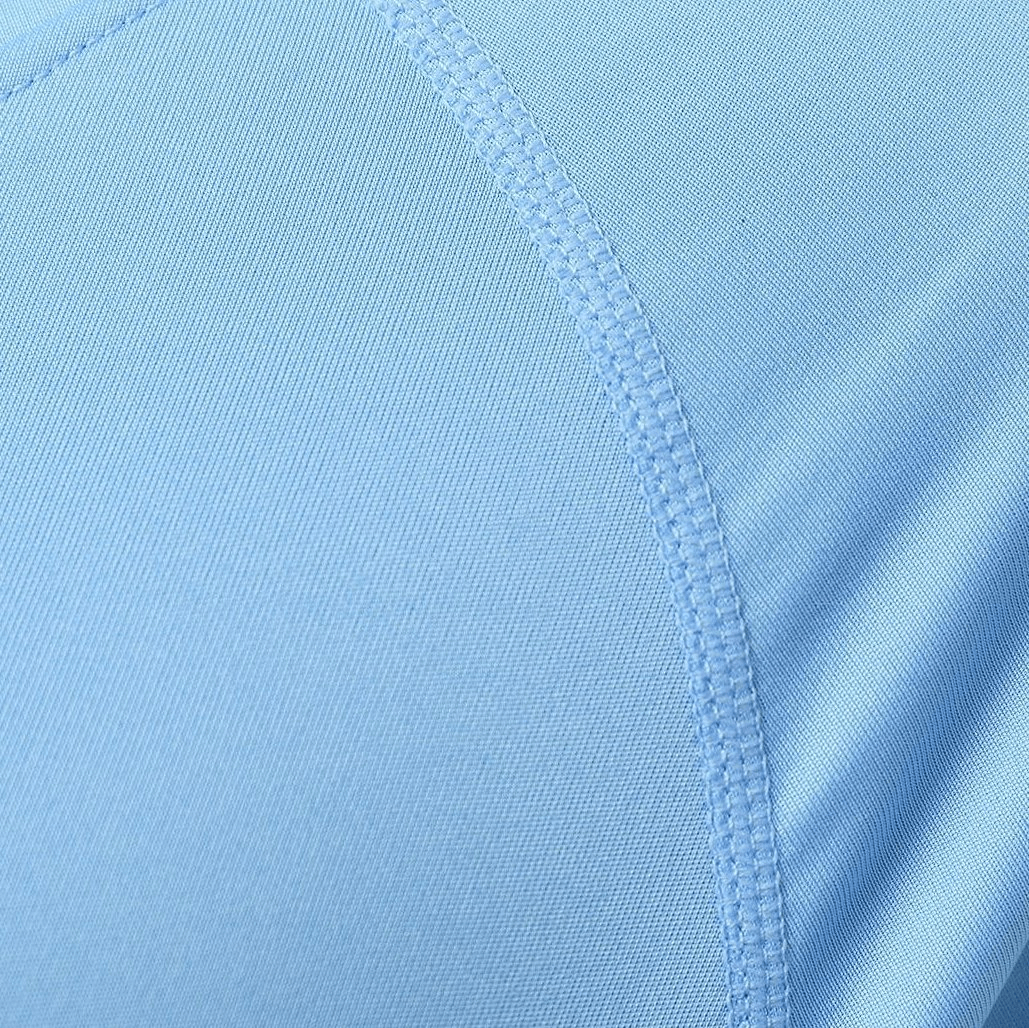 Close-up of light blue breathable polyester fabric on a quick-dry men's hooded shirt, showcasing its stitching and lightweight design.