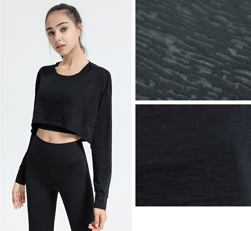 Black sports long-sleeved loose top showcasing texture and fit, perfect for yoga, gym, or running. Comfortable activewear for women.