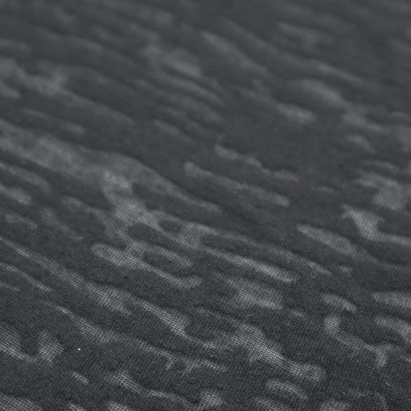 Close-up texture of black breathable fabric for sportswear, designed for comfort in various physical activities.