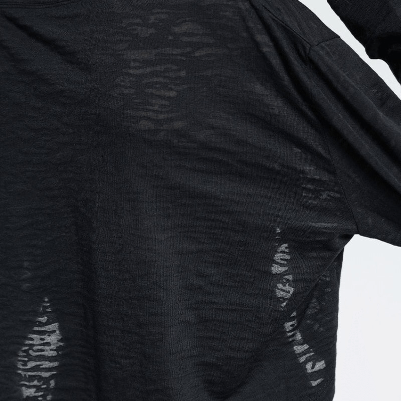 Close-up of black sports long-sleeved loose top, highlighting breathable cotton-polyester fabric. Ideal for fitness and active wear.
