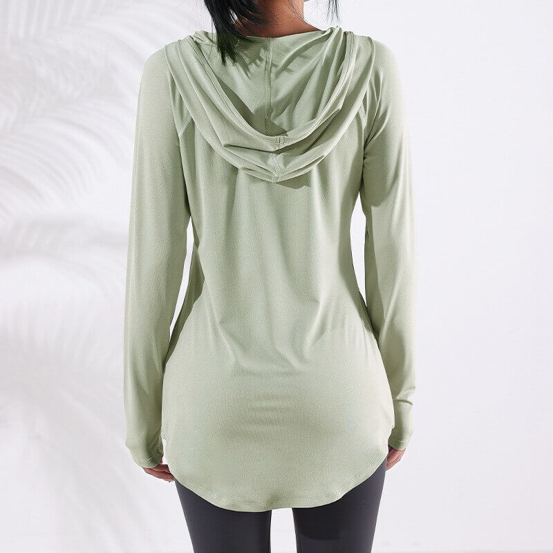 Back view of a woman wearing a light green sports loose hooded sweatshirt, ideal for yoga and running. Product code: SF1223