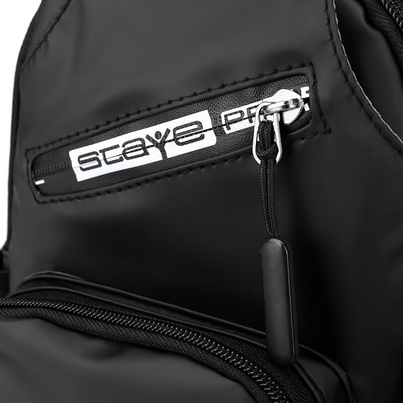 Close-up of black men's crossbody bag with USB-port and zipper details, made from durable nylon and polyester for everyday use.