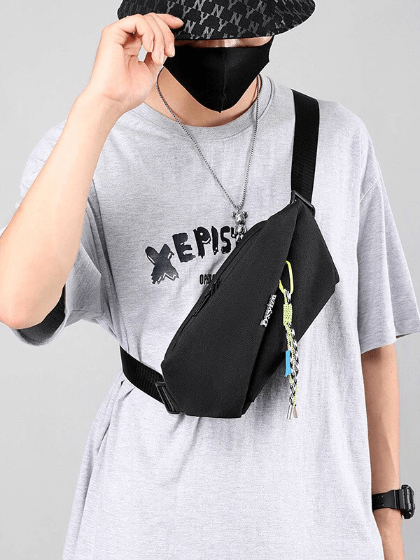 Sports Men's Waterproof Crossbody Chest Bag in black with removable tassel pendant, worn with casual grey t-shirt and hat.