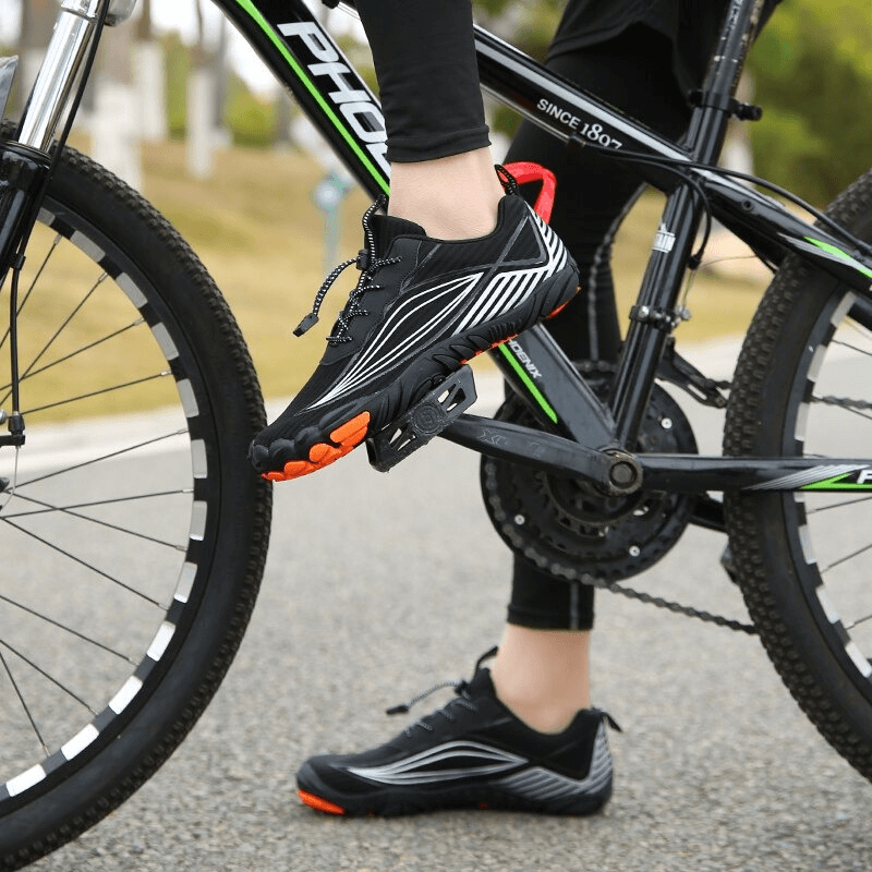 Person wearing Sports Mountain Bicycle Sneakers on a bicycle, showcasing lightweight sole and breathable design, perfect for outdoor adventures.