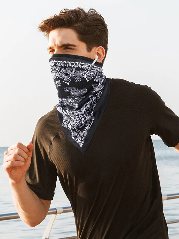 Athlete wearing sports neck gaiter while running outdoors, offering UV protection and breathability for cycling, fishing, and more.