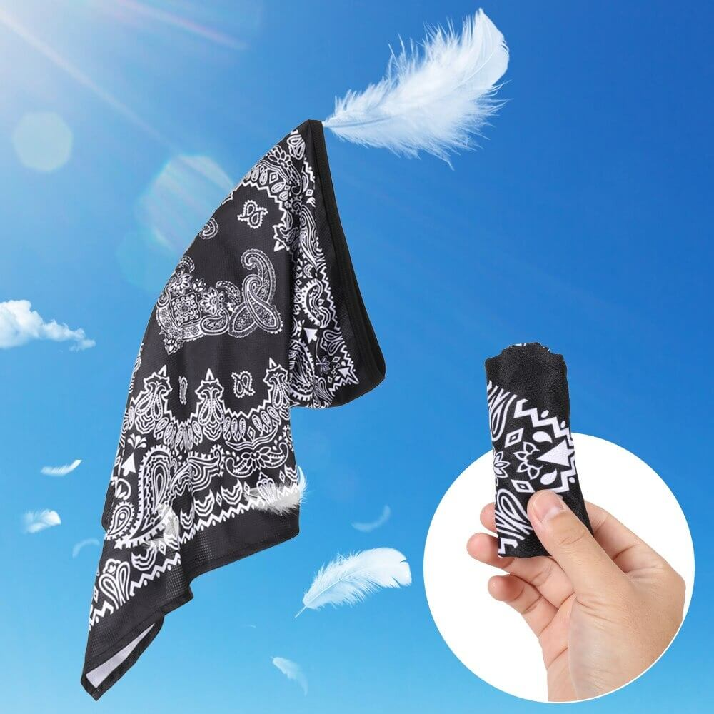 Lightweight black and white patterned sports neck gaiter floating in the sky, with a hand holding a compact version, ideal for outdoor sports.