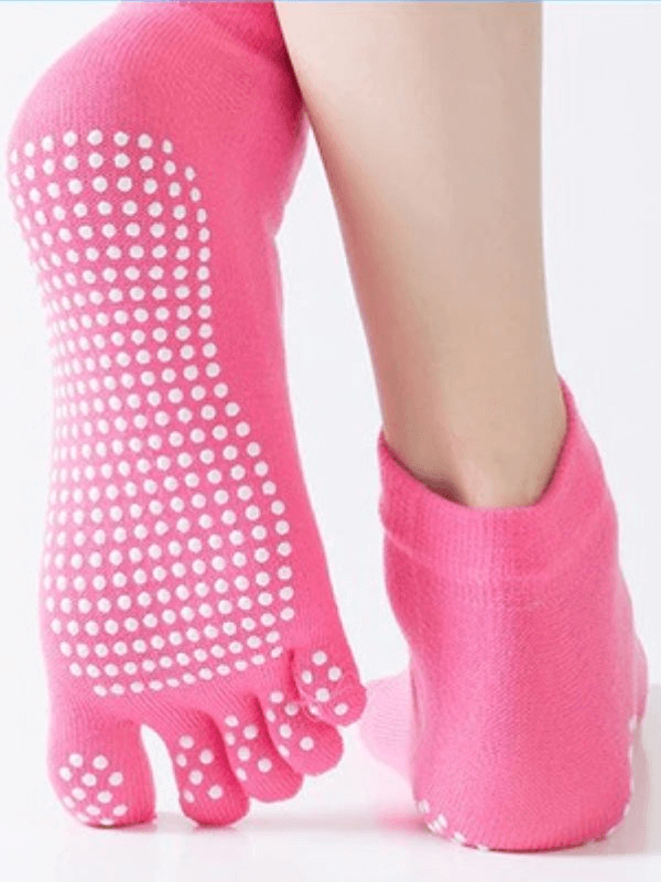 Pink non-slip quick-drying women's five-toe socks, perfect for yoga and sports activities, showcasing grip dots and separate toes.
