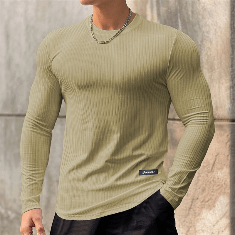 Man wearing sports quick dry men's long sleeve gym t-shirt, spandex-polyester blend, O-neck, stylish striped pattern, no hood.