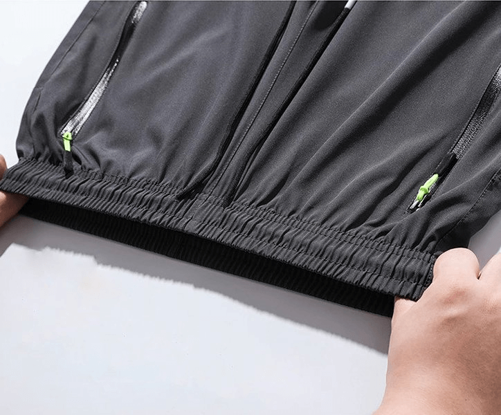 Elastic waist of quick-drying men's pants, showcasing breathable polyester fabric and pocket zippers, ideal for camping and hiking.
