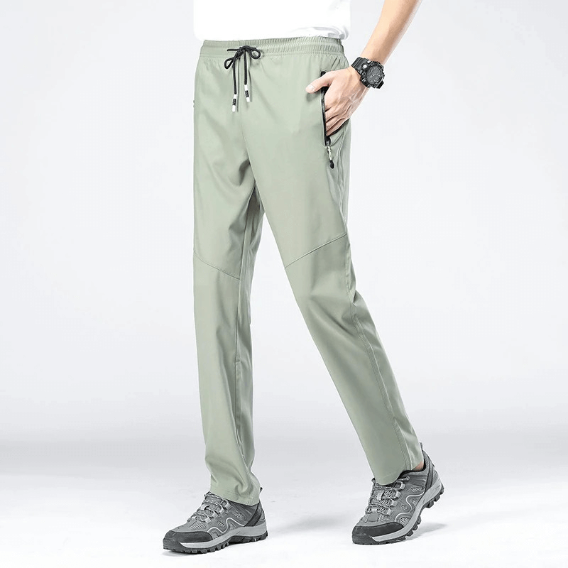 Model wearing quick-drying men's pants with pockets, SF0228, ideal for hiking, in breathable polyester with elastic waist for comfort.