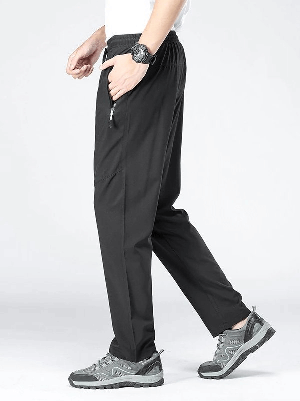 Side view of black sports quick-drying men's pants SF0228 with pockets and elastic waist, ideal for hiking and outdoor activities.