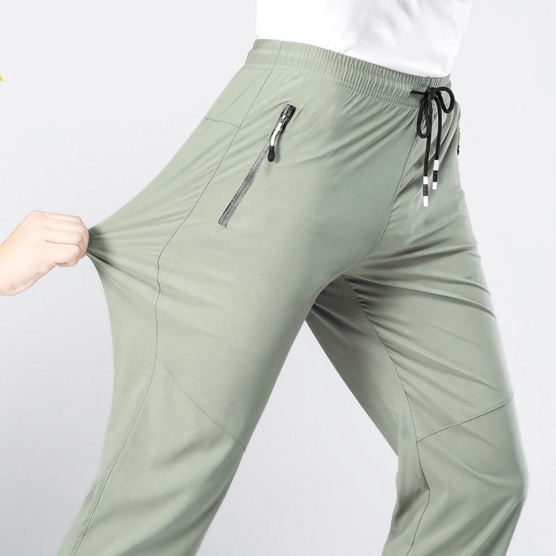 Model wearing Sports Quick-Drying Men's Pants SF0228, showcasing elastic waist and spacious pockets for outdoor activities.