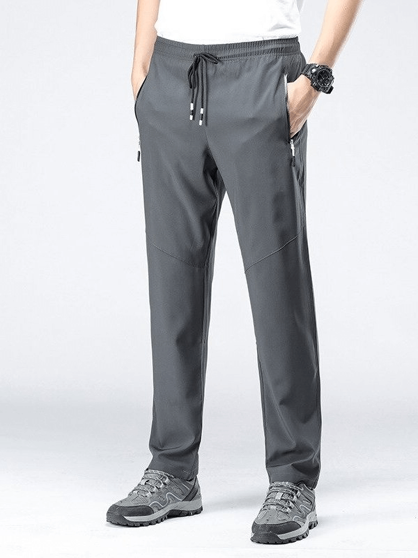 Gray quick-drying men's sports pants with pockets, elastic waist, full length, perfect for hiking and camping adventures.