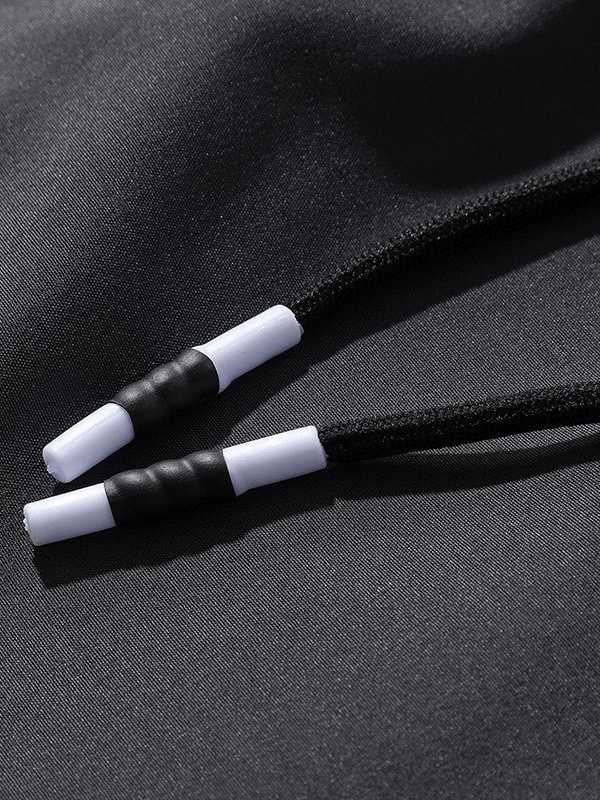 Close-up of drawstrings on sports quick-drying men's pants, highlighting durable material and design for active use.