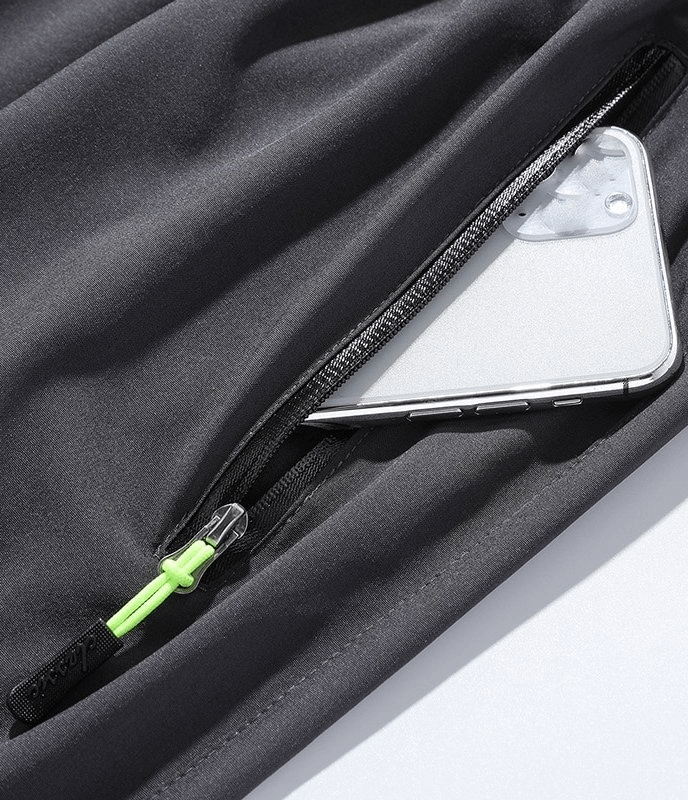 Quick-drying men's pants with pocket holding a smartphone, featuring a zipper and breathable polyester material. Great for outdoor activities.