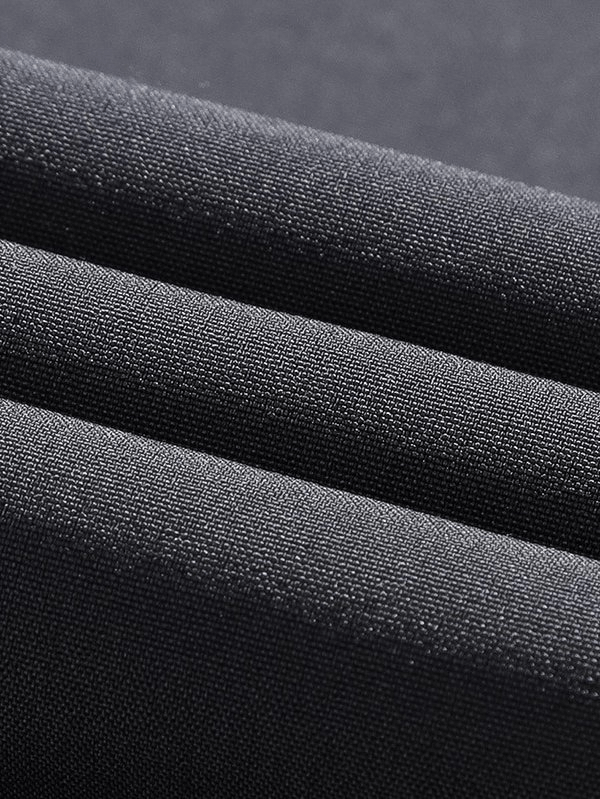 Close-up of black polyester fabric for sports quick-drying men's pants with a textured, smooth surface ideal for activewear.