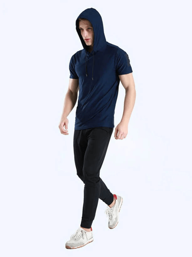 Man wearing navy blue sports quick-dry hooded t-shirt and black pants, ideal for running and workouts, showcasing comfort and fit.