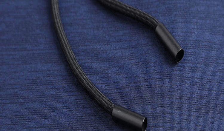 Close-up of a black drawstring on a blue fabric for sports running quick-dry T-shirt with hood.
