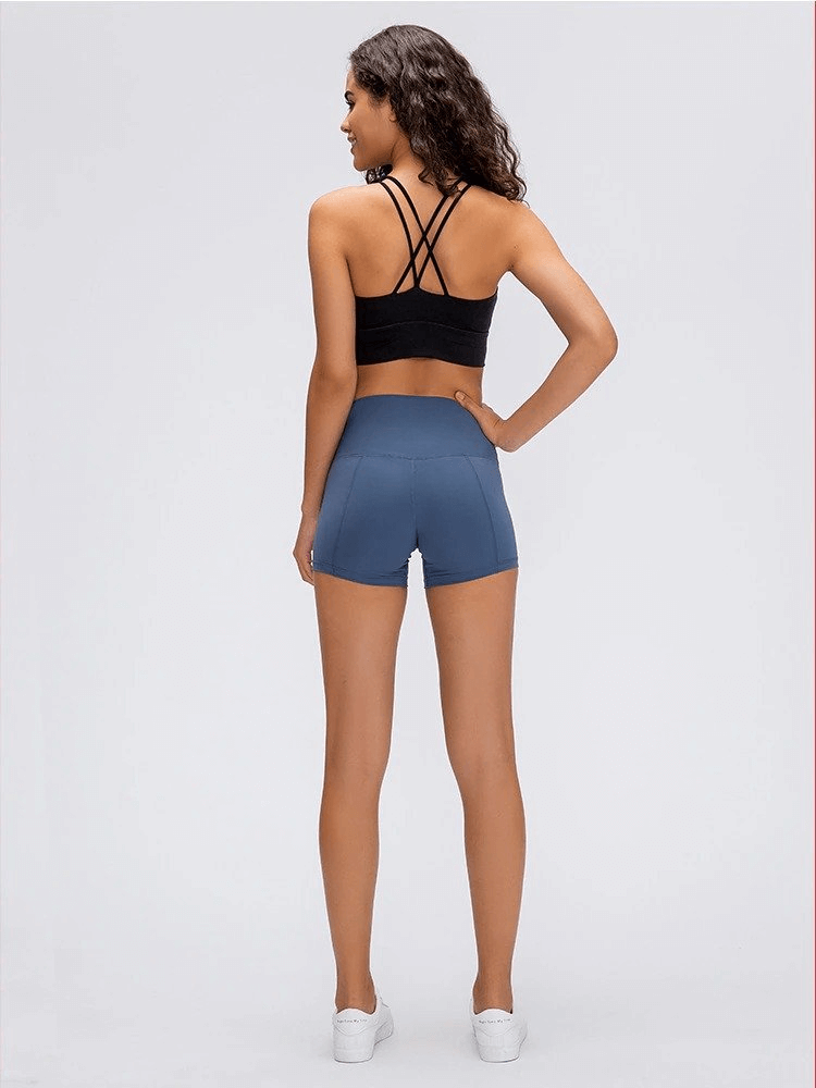 Woman wearing Sports Short Elastic Women's Training Shorts in blue, perfect for yoga and workouts with comfy nylon-spandex blend.
