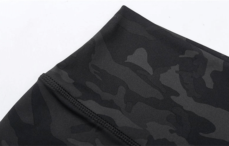 Close-up of black camouflage sports shorts fabric, showcasing stretchy, breathable material for women's training, yoga, and workouts.