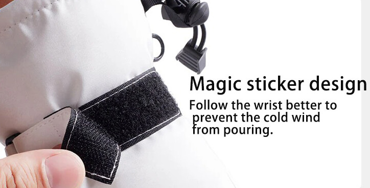 Close-up of magic sticker design on skiing glove, showing Velcro wrist strap to prevent cold wind, ideal for touch screen use during winter sports.