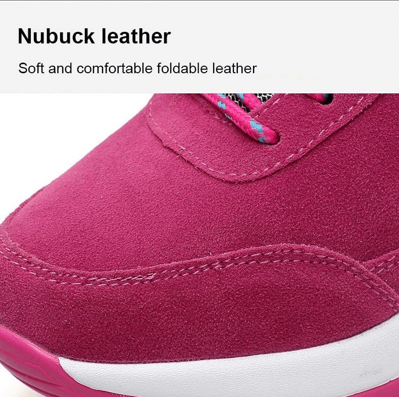Close-up of a pink nubuck leather sneaker, showcasing soft and comfortable foldable leather material with stitching details.