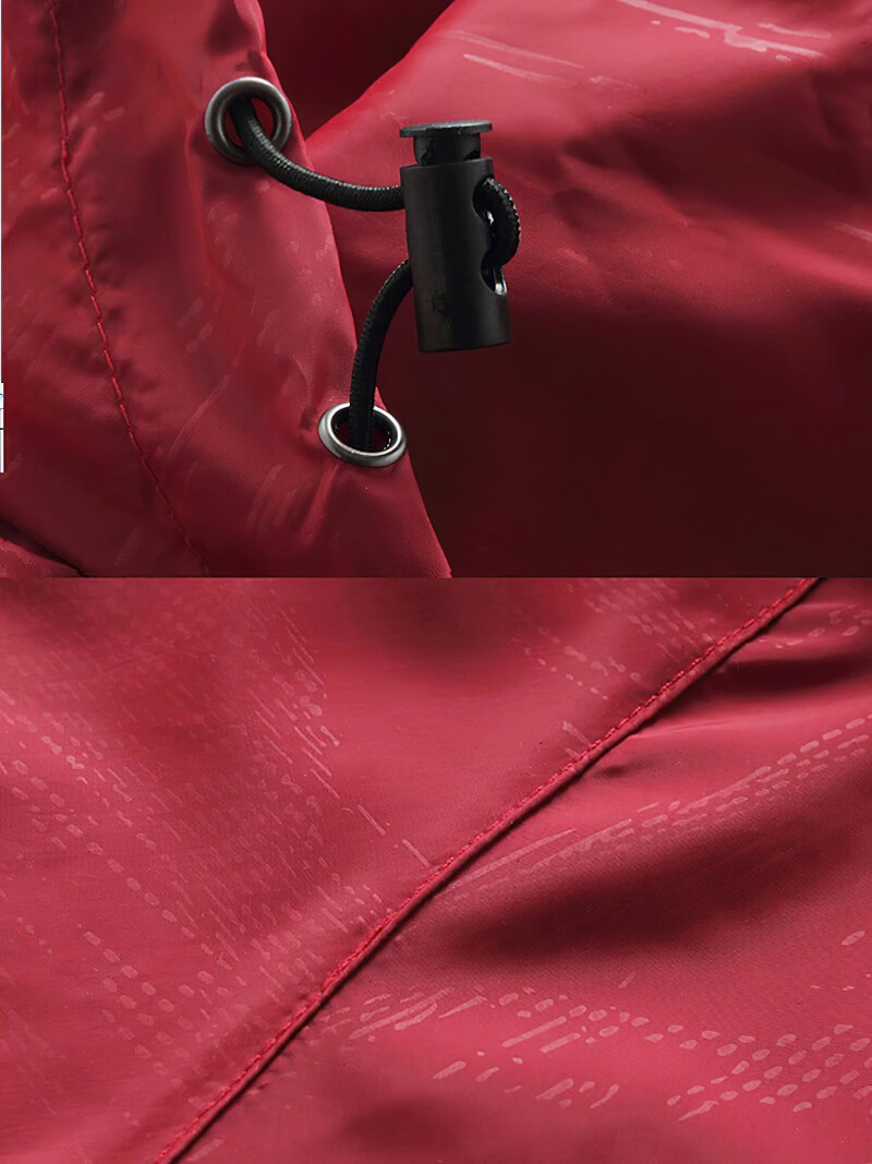 Close-up of red ultralight waterproof rain jacket fabric with adjustable drawstring and anti-static features.