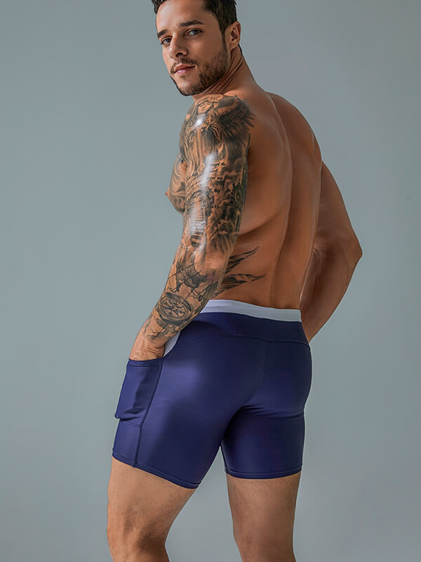 Model wearing navy sports waterproof beach boxer shorts with drawstring and pockets, showing back view, SF0772.