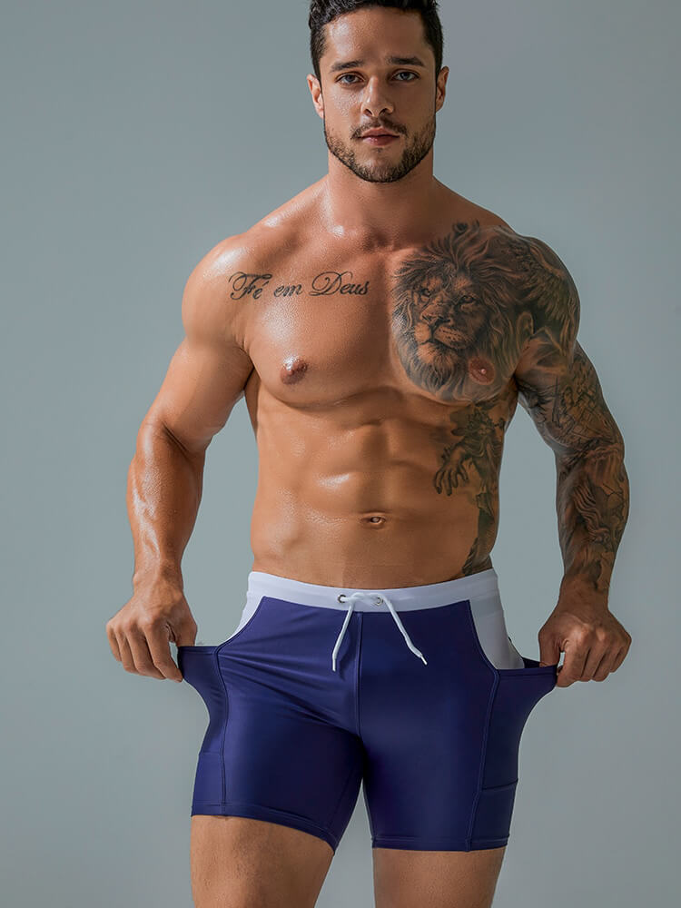 Model wearing sports waterproof beach boxer shorts with drawstring and pockets, showcasing lightweight nylon design.