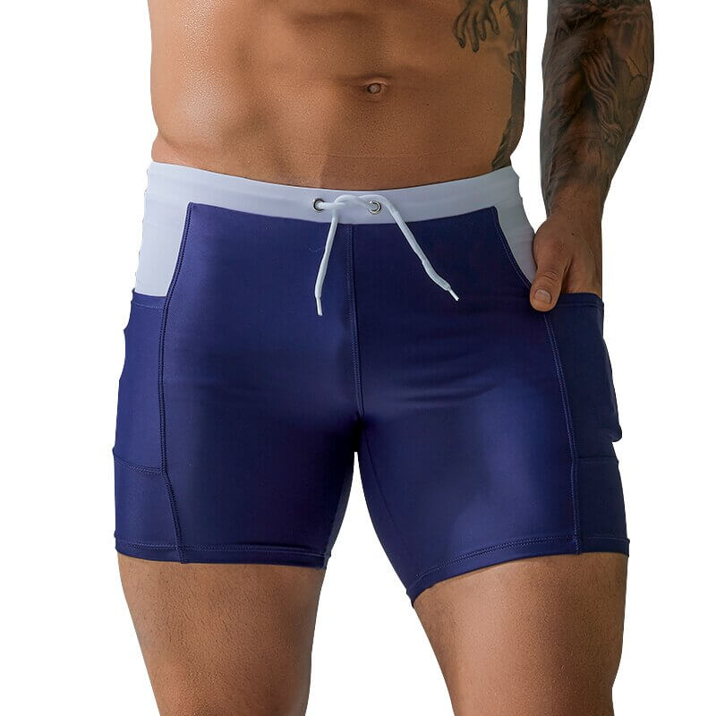 Men wearing navy waterproof beach boxer shorts with drawstring and pockets, perfect for sporty beach activities.