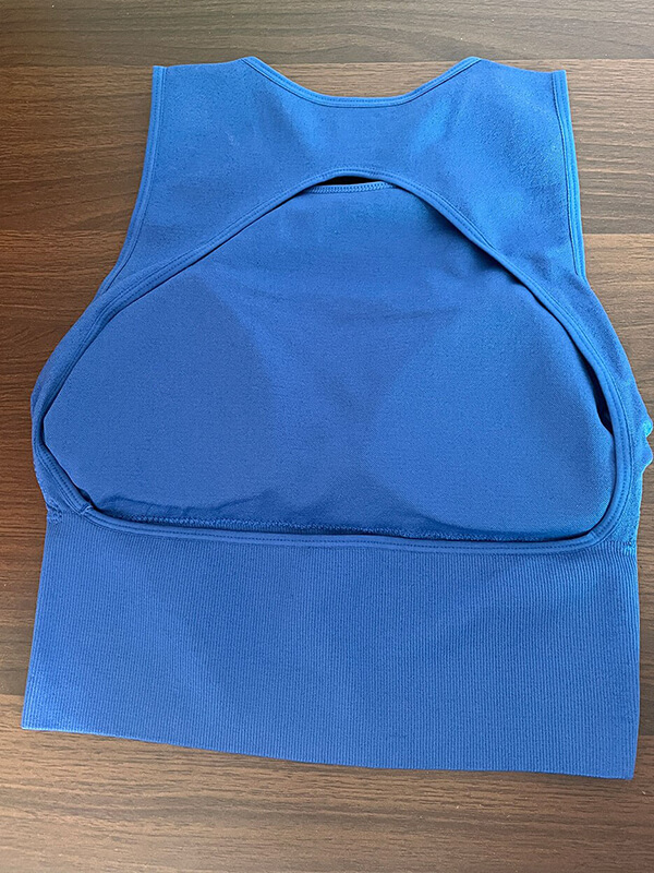 Blue backless sports tank top for women, ideal for Pilates and yoga, featuring breathable fabric and a stylish design.