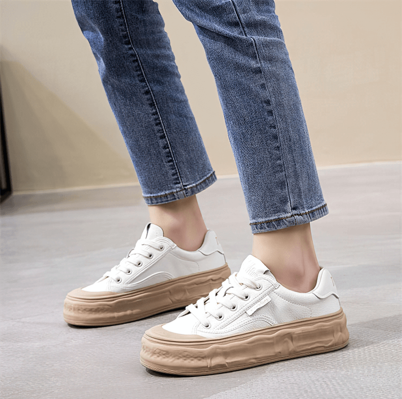 Woman wearing sports women's round toe lace-up sneakers with thick sole, showcasing stylish mixed colors for ultimate comfort and support.