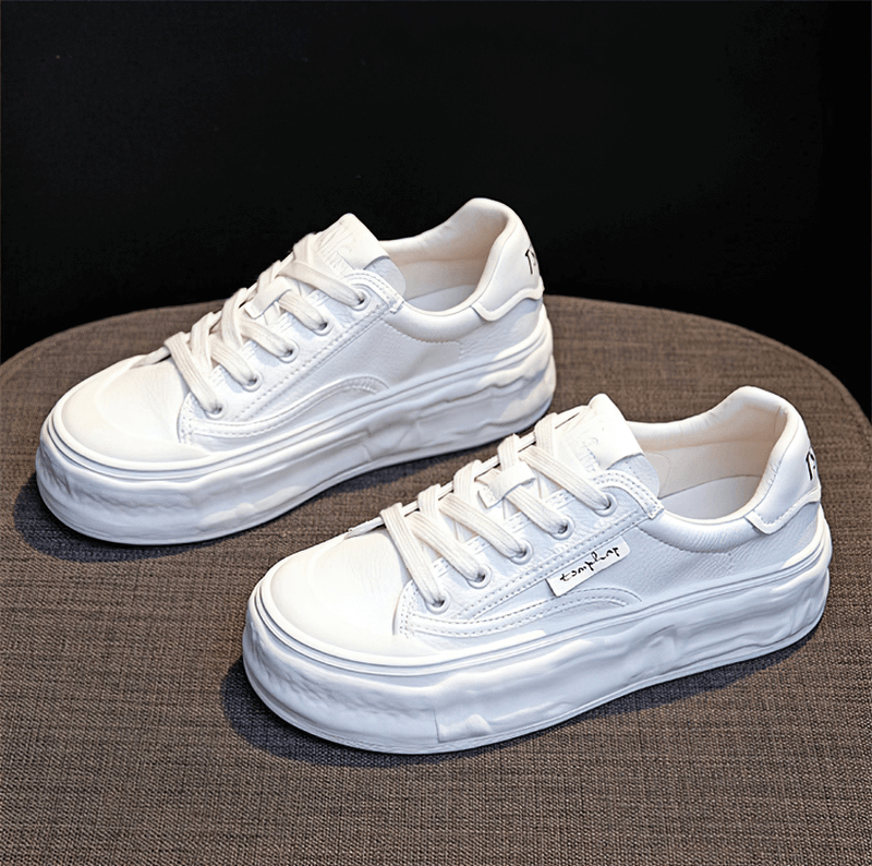 White women's round toe lace-up sneakers with thick sole, perfect for sporty comfort.