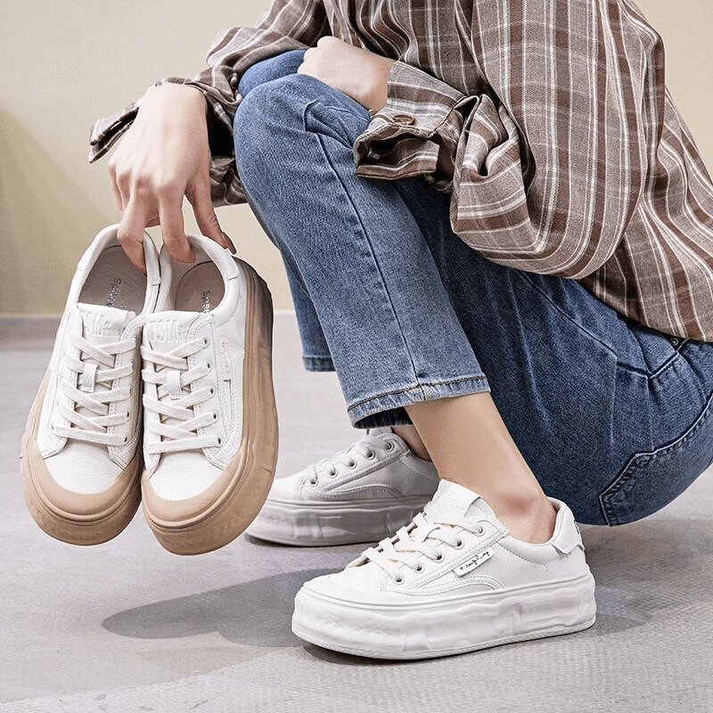 Person holding Women's Round Toe Lace-Up Sneakers with thick sole, highlighting comfort and style with a mixed color pattern.