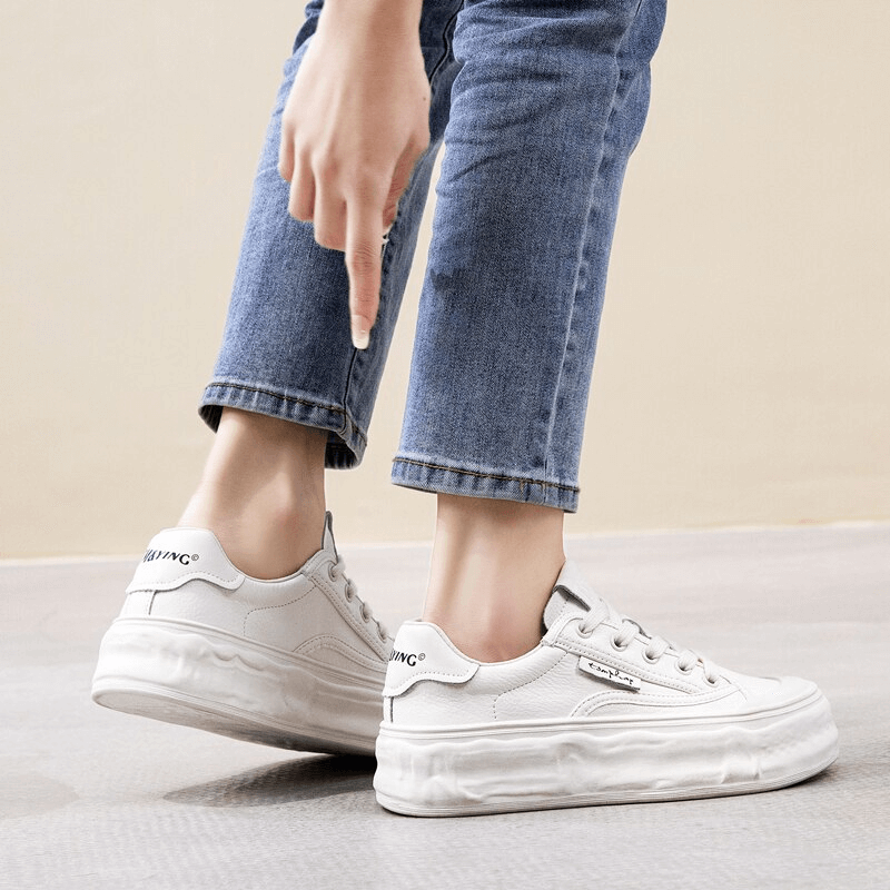 Alt Tag: White Women's Round Toe Lace-Up Sneakers with Thick Soles, perfect for comfort and style, paired with blue jeans.