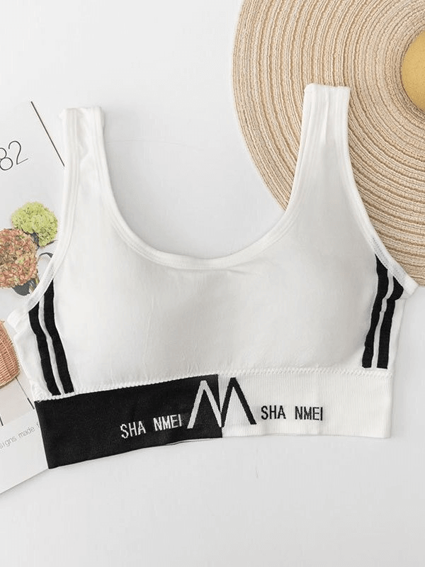 White sports women's seamless bra top with lining, featuring anti-chafing fabric and stylish black stripes, ideal for fitness activities.