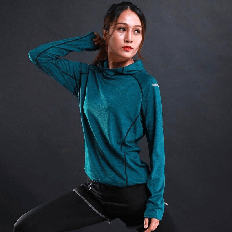 Woman wearing a teal thin long sleeves hoodie with reflective printing, ideal for gym fitness and running. Breathable and stylish activewear.