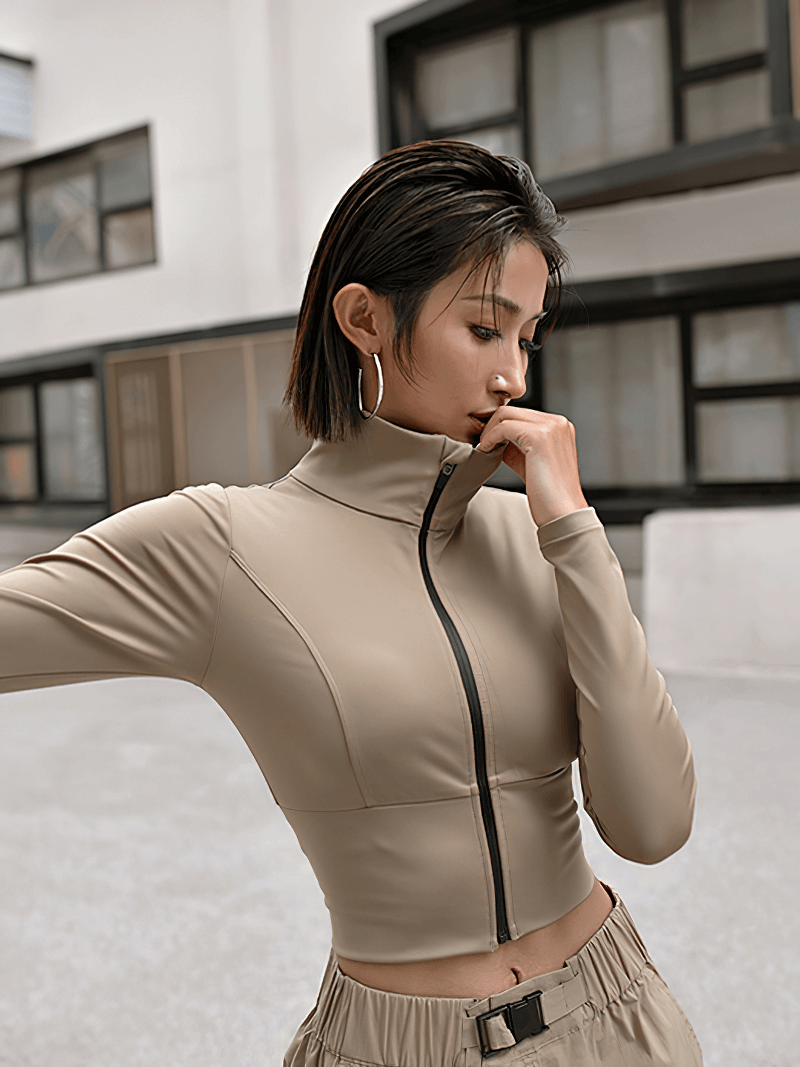 Woman wearing khaki sports zipper jacket with long sleeves and Mandarin collar, perfect for running and yoga.