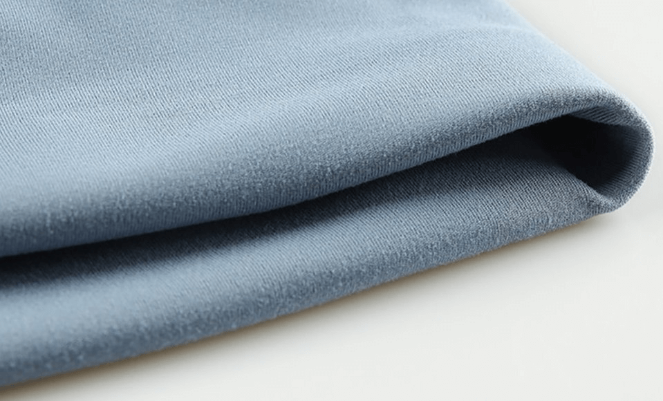 Close-up of sporty elastic women's short shorts in blue, highlighting the lightweight polyester-spandex fabric and solid pattern detail.