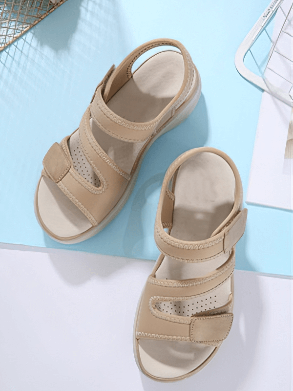 Sporty flexible women's open-toe flat sandals with fasteners in beige, featuring a comfortable platform and secure strap design.