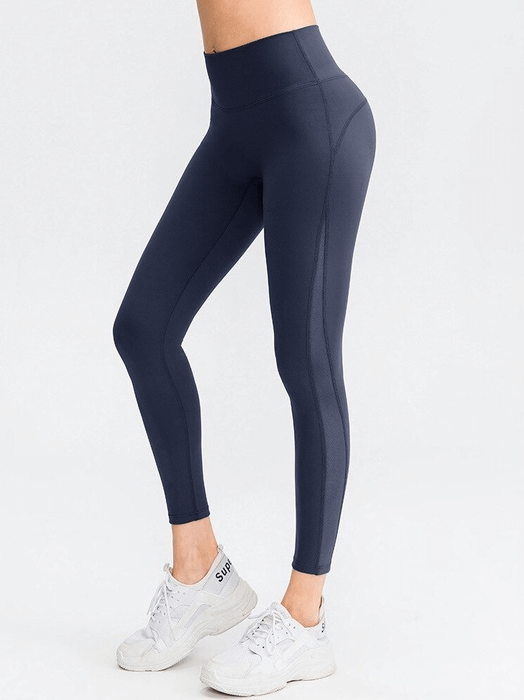 Sporty seamless women's leggings with high waist in navy blue, designed for yoga, offering flexibility, comfort, and support.