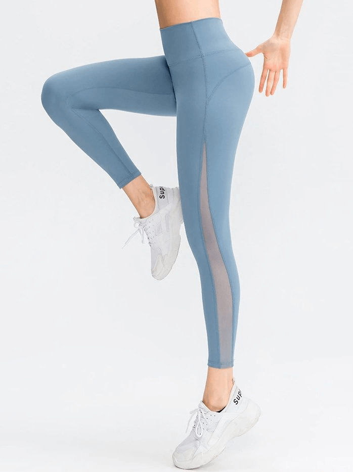 Woman in blue sporty seamless high-waist leggings demonstrating flexibility and comfort.