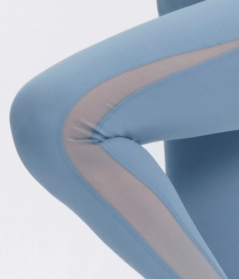 Close-up of blue sporty seamless women's leggings with high waist, highlighting sleek design and flexibility for yoga.
