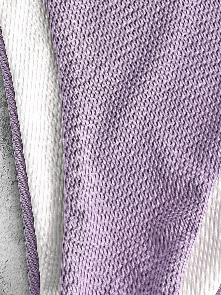 Close-up of ribbed purple and white bikini fabric, showcasing elegant texture and high-quality material