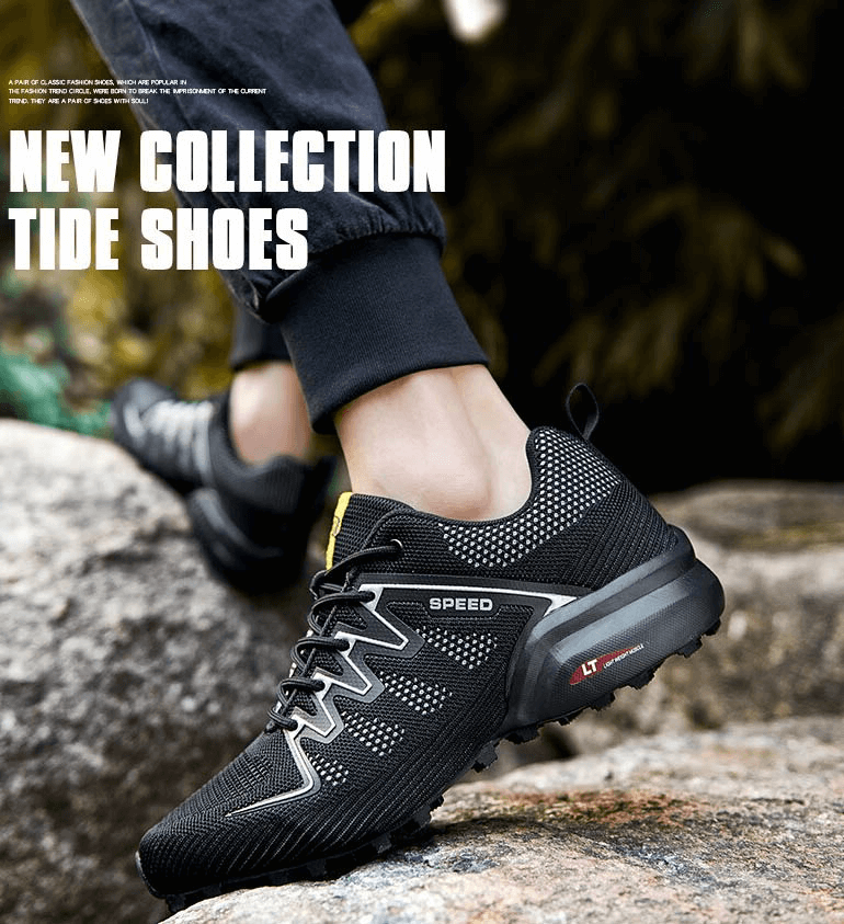 Men's black air mesh gym shoes with drainage sole and stylish design on rocky terrain.