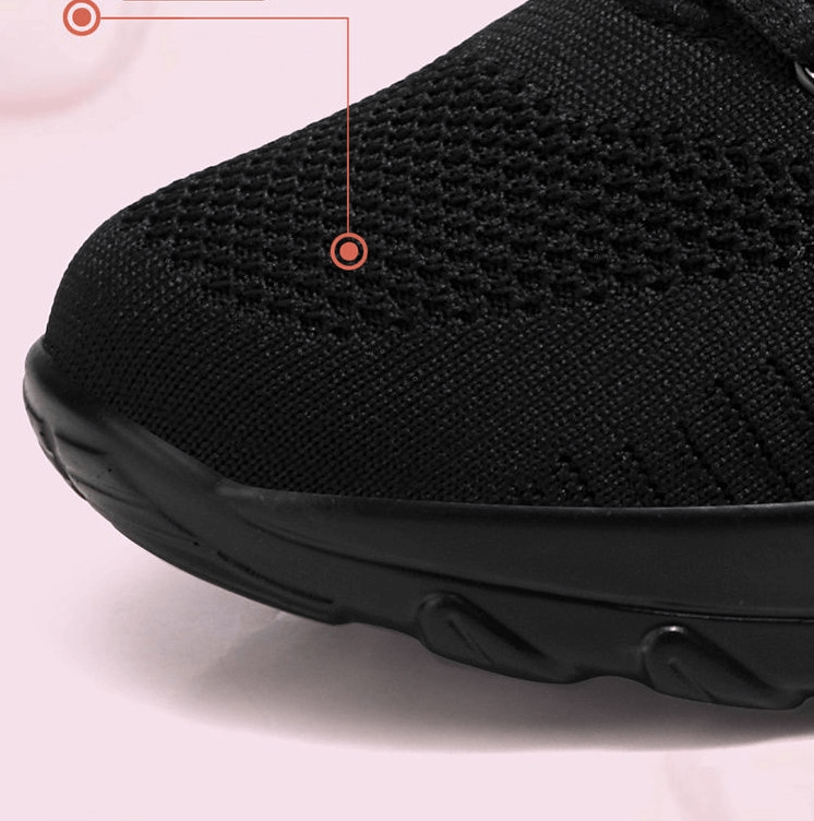 Close-up of stylish breathable black women's sneaker with mesh air upper and flexible sole, perfect for active wear.