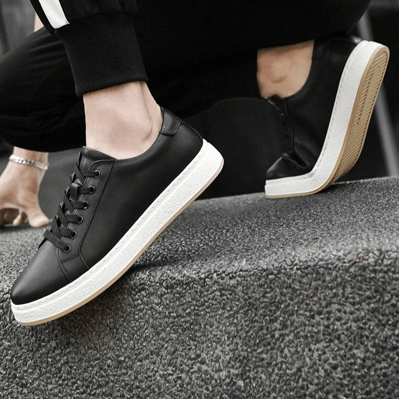 Stylish breathable genuine leather men's shoes SF1170 with rubber outsole on steps, showcasing sleek black design and comfortable fit.