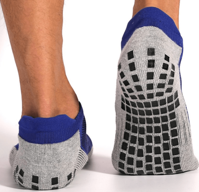 Stylish breathable non-slip sports socks with silicone soles shown on feet, featuring tear-resistant material for unisex football playing.