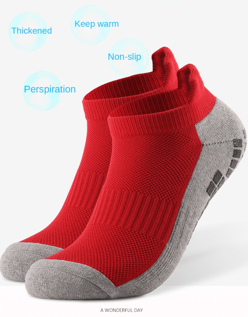 Red and grey breathable sports socks with non-slip silicone soles for football players, designed for comfort and support.